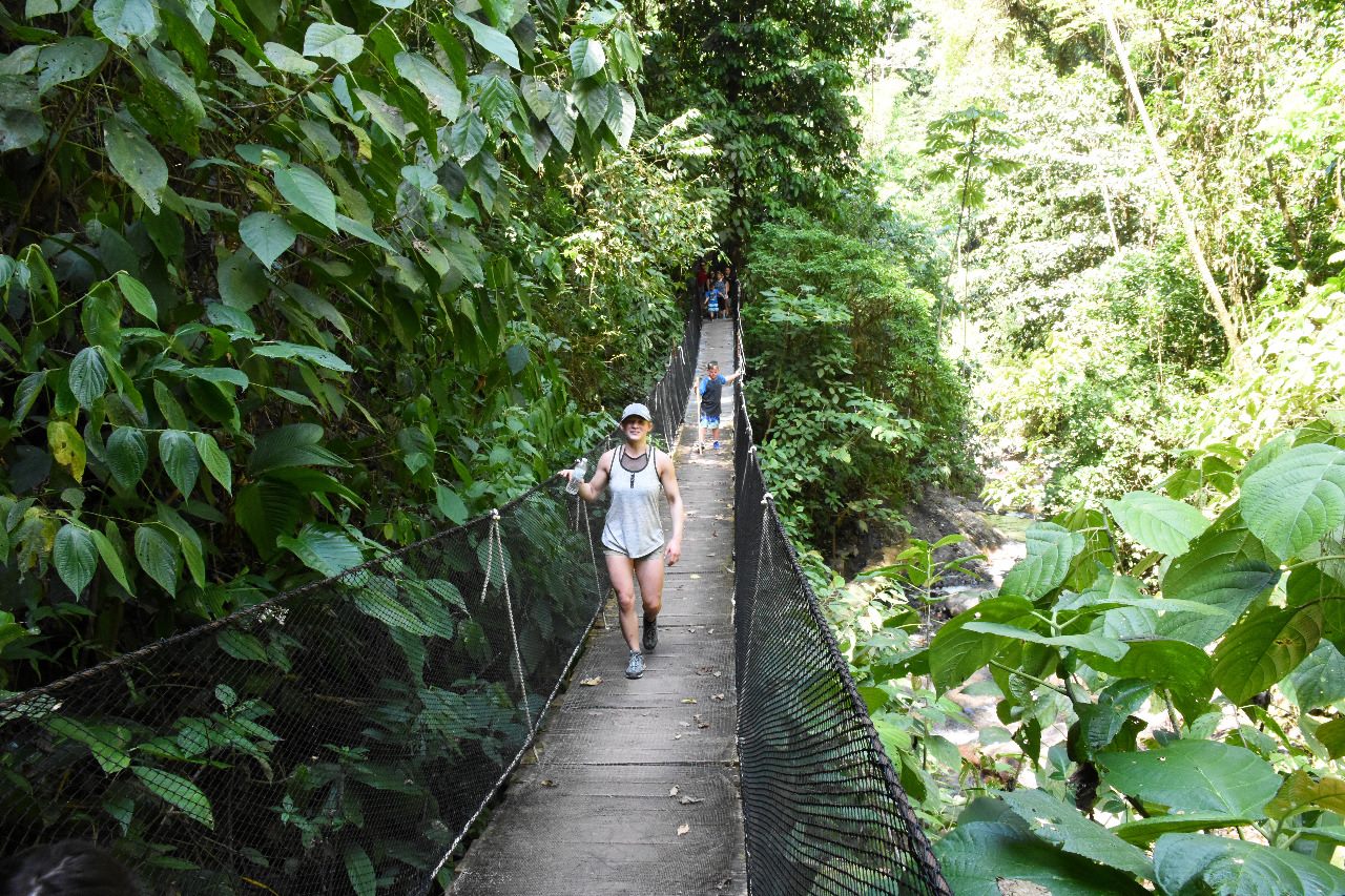 Guest crossing a suspension bridge at Rainmaker rainforest
